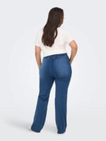 ryggen af model med blå jeans med bred elastik i taljen. ONLY Carmakoma CARROYAL Flared Legging Medium Blue Denim